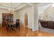 Traditional dining room features hardwood floors, chandelier, and view of living room at 2148 Ne Indian Shoals Dr, Loganville, GA 30052