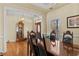 Elegant dining room featuring hardwood floors, a wooden table, and ample natural light at 2148 Ne Indian Shoals Dr, Loganville, GA 30052