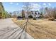 Lovely home exterior featuring mature trees, a large front yard, and a long driveway at 2148 Ne Indian Shoals Dr, Loganville, GA 30052