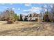 Beautiful home with a large front yard, showcasing its curb appeal and serene setting at 2148 Ne Indian Shoals Dr, Loganville, GA 30052