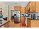 Kitchen with stainless steel appliances, wooden cabinets, and an eat-in dining area at 2148 Ne Indian Shoals Dr, Loganville, GA 30052