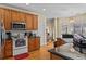 Well-lit kitchen with granite countertops, stainless steel appliances, and wooden cabinetry at 2148 Ne Indian Shoals Dr, Loganville, GA 30052