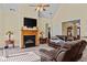 Cozy living room with fireplace, plush seating, and ample natural light at 2148 Ne Indian Shoals Dr, Loganville, GA 30052