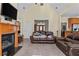 Open living room features a fireplace, comfortable seating, and ample natural light at 2148 Ne Indian Shoals Dr, Loganville, GA 30052