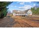 Back of house featuring an expansive yard, screened porch, and partial brick facade at 2148 Ne Indian Shoals Dr, Loganville, GA 30052