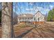 Charming home exterior with a spacious screened porch overlooking the private backyard at 2148 Ne Indian Shoals Dr, Loganville, GA 30052