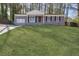 Charming single-story brick home with a manicured lawn and inviting front porch in a wooded neighborhood at 2350 Brenda Se Dr, Smyrna, GA 30080
