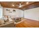 Cozy living room with hardwood floors, exposed wood ceiling, and a comfortable sectional sofa at 2350 Brenda Se Dr, Smyrna, GA 30080
