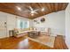 Bright living room with hardwood floors, exposed wood ceiling, a large window, and a comfortable sectional sofa at 2350 Brenda Se Dr, Smyrna, GA 30080