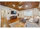 Cozy living room featuring hardwood floors, wooden ceiling, and ample natural light at 2350 Brenda Se Dr, Smyrna, GA 30080