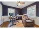 Comfortable home office with hardwood floors, wainscoting, a ceiling fan, and a brown leather reclining chair at 2350 Brenda Se Dr, Smyrna, GA 30080
