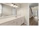 Bright bathroom with a vanity, a large mirror, and a tiled floor, providing a clean and functional space at 5215 Willow Creek Overlook, Woodstock, GA 30188