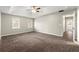 This spacious bedroom features plush carpeting, a tray ceiling with fan, and sun-filled windows at 5215 Willow Creek Overlook, Woodstock, GA 30188