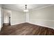 Elegant dining room featuring hardwood floors, crown molding, and a stylish light fixture for Gathering gatherings at 5215 Willow Creek Overlook, Woodstock, GA 30188