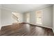 Inviting living room with hardwood floors, crown molding, and plenty of natural light from the large windows at 5215 Willow Creek Overlook, Woodstock, GA 30188