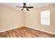 Bright bedroom with natural light, ceiling fan, and wood-look floors at 653 Inland Way, Lilburn, GA 30047