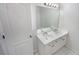 Bright bathroom featuring a double vanity with white cabinets and a large mirror at 107 Red Barn Ln, Acworth, GA 30102
