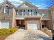 Charming townhome with a one-car garage and classic brick and siding exterior at 107 Red Barn Ln, Acworth, GA 30102