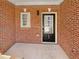 Welcoming front porch with brick facade and view of front door at 107 Red Barn Ln, Acworth, GA 30102