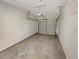 Empty single-car garage with concrete flooring and a closed door at 107 Red Barn Ln, Acworth, GA 30102