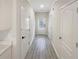 Bright hallway featuring modern gray flooring and leading to a white front door at 107 Red Barn Ln, Acworth, GA 30102