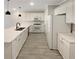 Modern kitchen with white cabinets, stainless steel appliances, and long countertops at 107 Red Barn Ln, Acworth, GA 30102