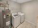 Laundry area equipped with washer, dryer, and shelving for storage at 107 Red Barn Ln, Acworth, GA 30102
