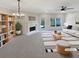 Bright, staged living room with a fireplace, bookshelf, and neutral decor at 107 Red Barn Ln, Acworth, GA 30102