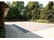 Outdoor pool area featuring a secure pool cover and surrounded by lush greenery and mature trees at 107 Red Barn Ln, Acworth, GA 30102