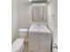 Small powder room with updated vanity, lighting, mirror and toilet at 107 Red Barn Ln, Acworth, GA 30102