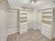 Walk-in closet with built-in shelving and drawers for optimal storage at 107 Red Barn Ln, Acworth, GA 30102