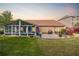 Spacious backyard featuring a screened porch, brick patio, and well-maintained lawn at 1119 Simonton Glen Way, Lawrenceville, GA 30045