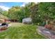 Well manicured backyard with a storage shed, mature trees and landscaping at 1119 Simonton Glen Way, Lawrenceville, GA 30045