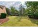 This home has a large manicured backyard with healthy green grass and mature landscaping at 1119 Simonton Glen Way, Lawrenceville, GA 30045