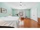 Spacious bedroom with hardwood floors, ceiling fan, and a large window with natural light at 1119 Simonton Glen Way, Lawrenceville, GA 30045