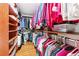Walk-in closet with custom shelves and hanging rods for ample storage space with wood flooring at 1119 Simonton Glen Way, Lawrenceville, GA 30045