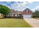 Beautifully landscaped home with brick and siding, a two-car garage, and a welcoming front lawn at 1119 Simonton Glen Way, Lawrenceville, GA 30045