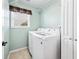Efficient laundry room with modern, front-loading washer and dryer, and ample storage at 1119 Simonton Glen Way, Lawrenceville, GA 30045