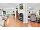 Open-concept living room with fireplace, hardwood floors, and seamless flow to dining area at 1119 Simonton Glen Way, Lawrenceville, GA 30045