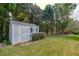 Backyard features a large storage shed with manicured landscaping at 1119 Simonton Glen Way, Lawrenceville, GA 30045