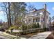 Exterior elevation with a charming front porch, manicured landscaping, and a circular driveway at 18 Polo Ne Dr, Atlanta, GA 30309