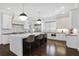 A modern kitchen with stainless steel appliances, a large center island, and white cabinetry at 18 Polo Ne Dr, Atlanta, GA 30309