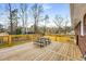 Exterior view of a wood deck with a picnic table and benches at 2831 Spruce Point Rd, South Fulton, GA 30349