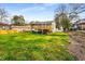 View of home's backyard and deck with grass and blue sky at 2831 Spruce Point Rd, South Fulton, GA 30349
