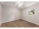 Bright bedroom with hardwood floors, ceiling fan, and a window offering natural light at 2831 Spruce Point Rd, South Fulton, GA 30349