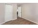 Bedroom with wood-look flooring with closet and entry door at 2831 Spruce Point Rd, South Fulton, GA 30349