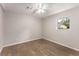 Bedroom featuring wood-look flooring, updated ceiling fan, and bright window at 2831 Spruce Point Rd, South Fulton, GA 30349