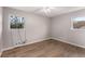 Neutral bedroom with wood-look flooring, two windows, and modern climate control at 2831 Spruce Point Rd, South Fulton, GA 30349