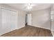 This bedroom features wood-look flooring, a ceiling fan, and a double door closet at 2831 Spruce Point Rd, South Fulton, GA 30349