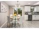 Bright dining area with a glass table, seating for four, and sliding glass doors to a deck at 2831 Spruce Point Rd, South Fulton, GA 30349